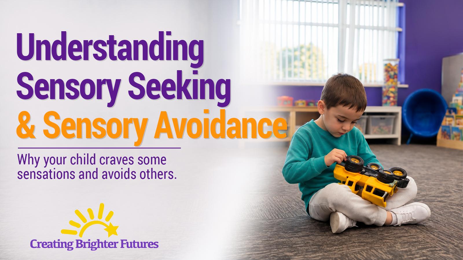 A young boy sits cross-legged on a classroom carpet, holding a yellow toy truck upside down and spinning its wheels, a common form of sensory-seeking play.